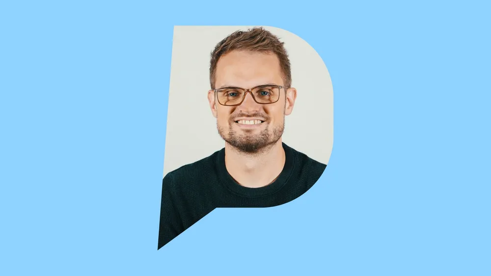 Daniel Seidel lächelt, Porträt in der Pulse-Sprechblase auf hellblauem Grund