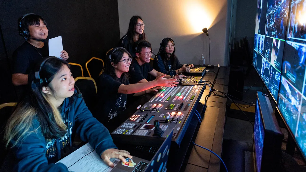Young people wearing headsets run the video mixing desk during the service at Heart of God Church in Singapore