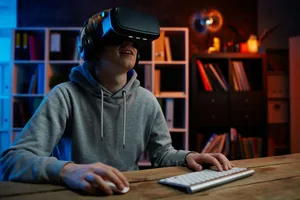 Un jeune homme portant un casque de réalité virtuelle joue à un jeu vidéo